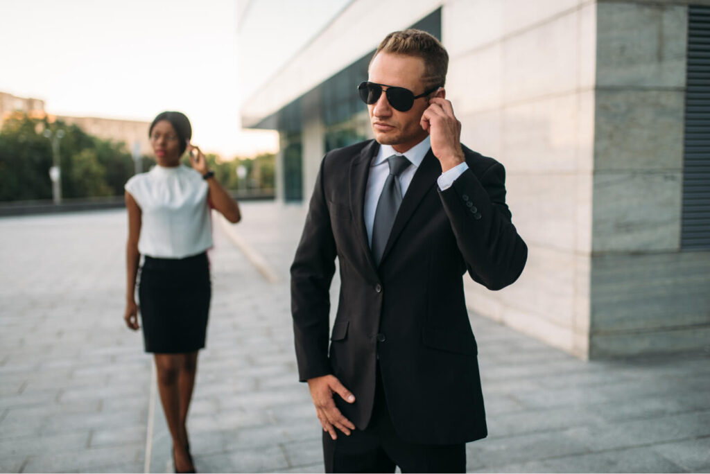 bodyguard in sunglasses and black business woman 2021 08 26 16 27 08 utc