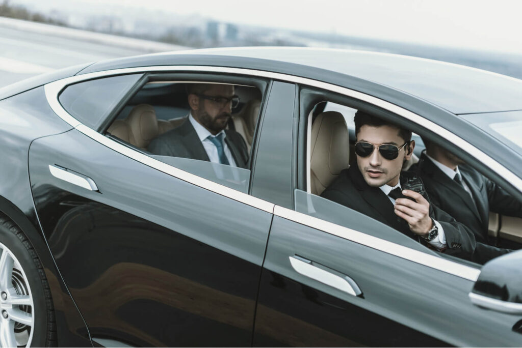bodyguards-and-businessman-sitting-in-a-black-car-2021-09-03-21-02-06-utc.jpg
